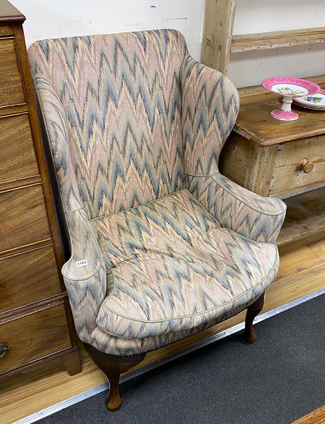 A George III style upholstered wing armchair, width 84cm, depth 75cm, height 112cm